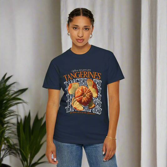 Person wearing a navy blue t-shirt with a graphic design WHEN LIFE GIVES YOU TANGARINES ARCHVSTS™ on a white background