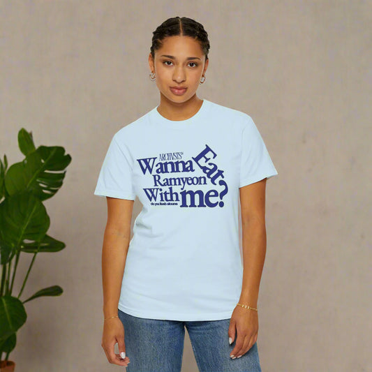 Person wearing a light blue t-shirt with text wanna eat ramenyon with me on a white background