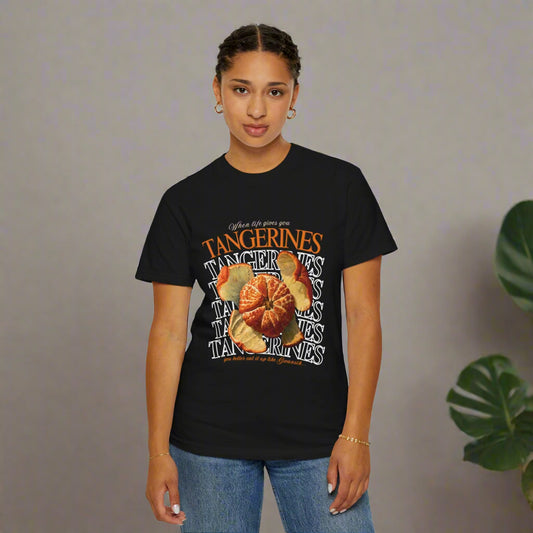 Person wearing a black WHEN LIFE GIVES YOU TANGARINES ARCHVSTS™ TSHIRT t-shirt with a graphic design and text on a white background