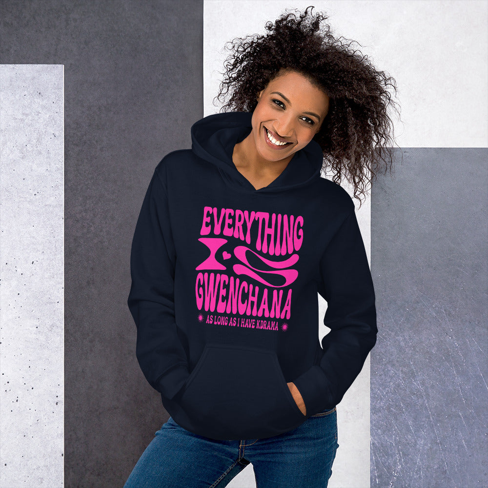 Woman wearing a navy hoodie with pink text Everything is Gwenchana Hoodie ARCHVSTS™from against a gray and white background