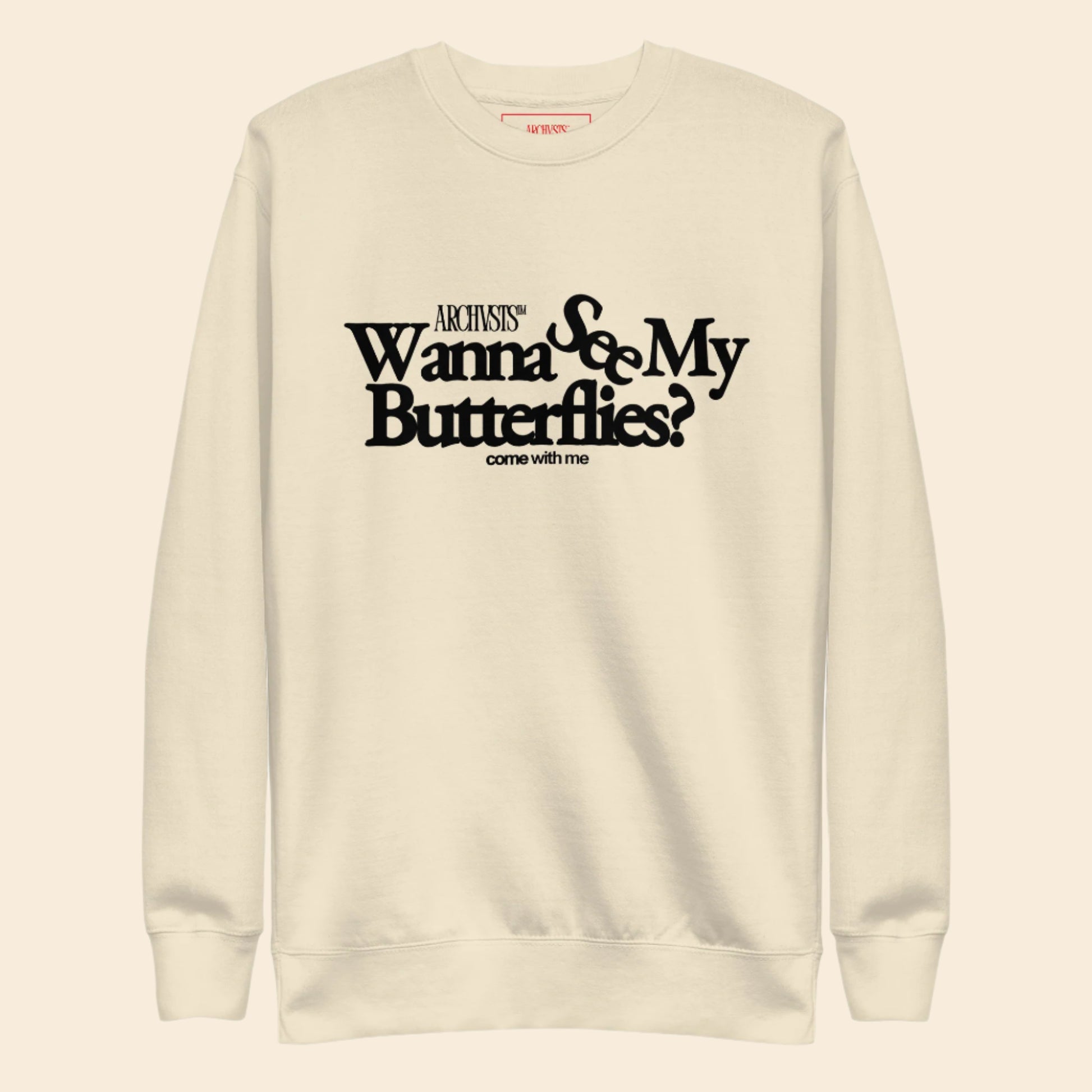 Beige sweatshirt with black text wanna see my butterflies on a white background