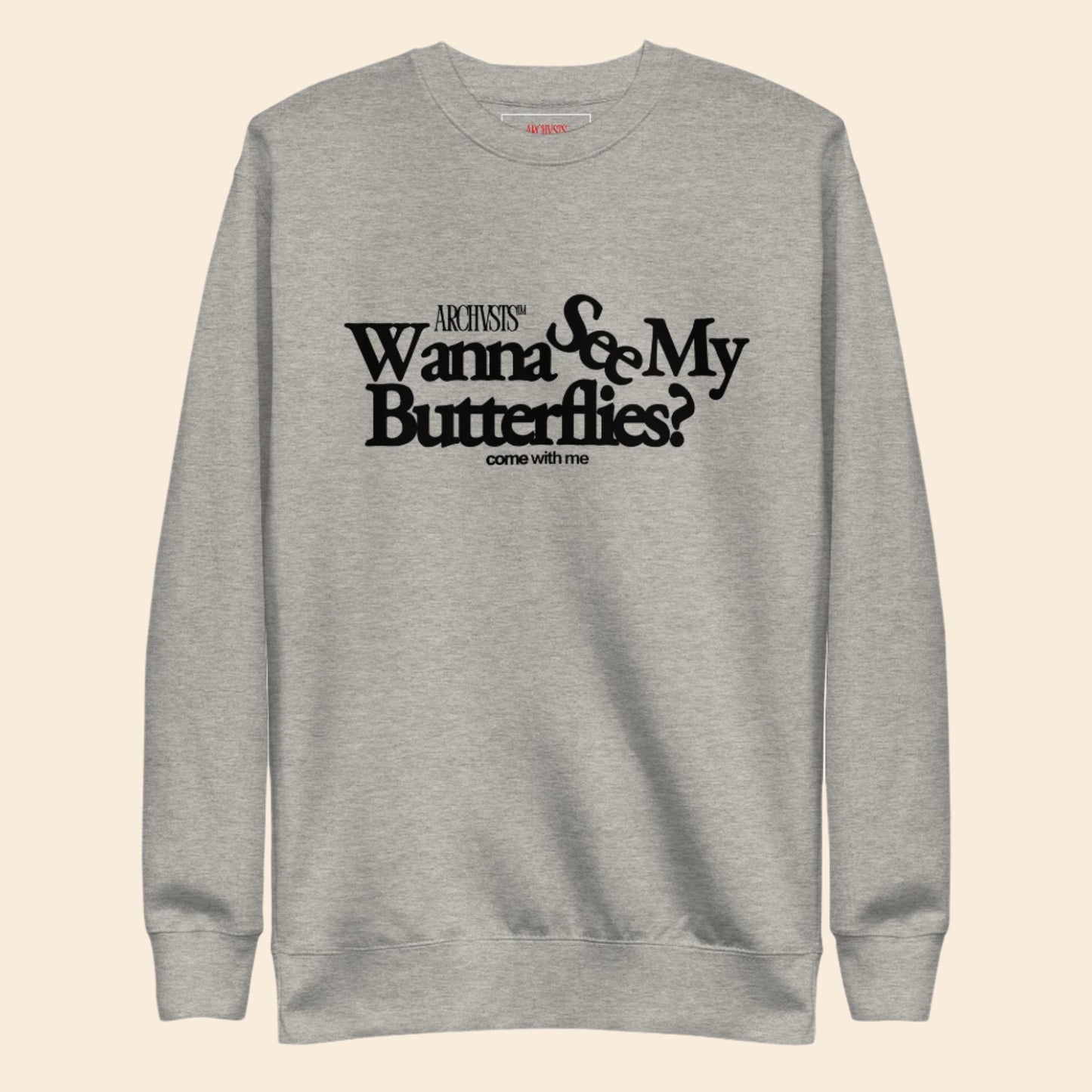 Gray sweatshirt with black text wanna see my butterflies on a white background