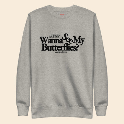 Gray sweatshirt with black text wanna see my butterflies on a white background