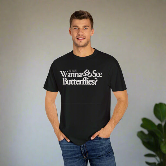 Man wearing a black t-shirt with text wanna go see butterflies on a white background
