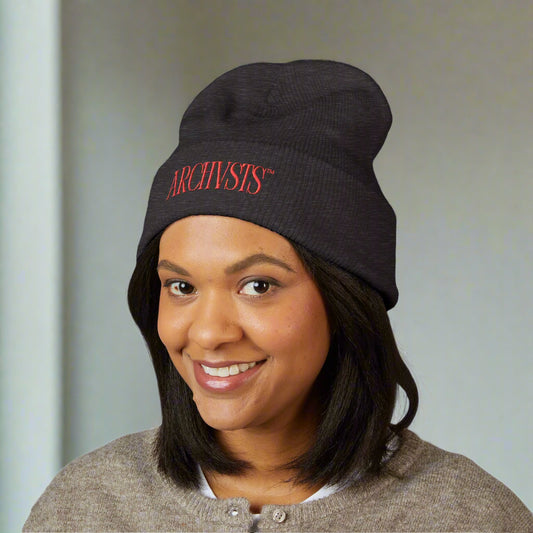 Person wearing a black beanie with 'Archivists' text on a white background