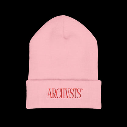 Pink beanie with 'ARCHIVSTS' logo on a white background