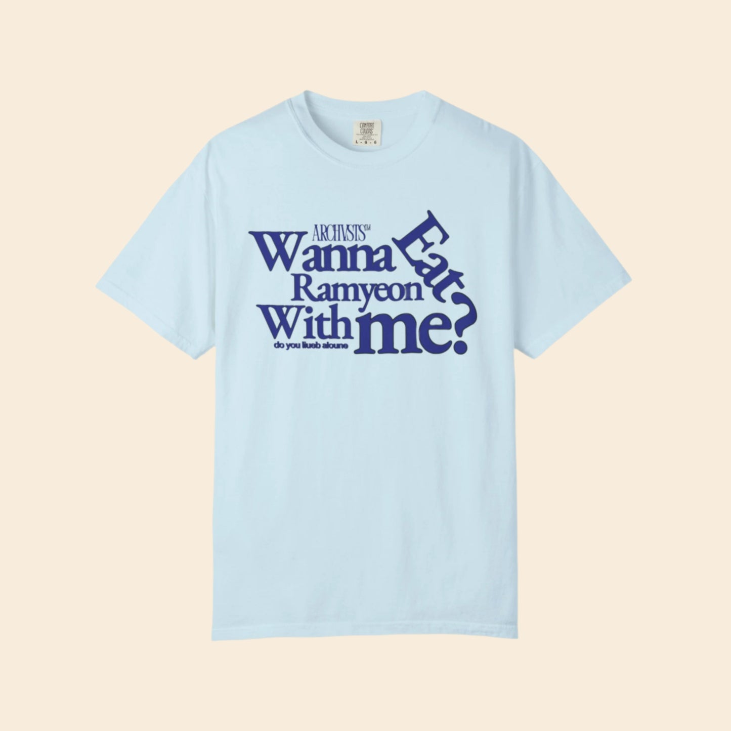 Light blue t-shirt with blue text wanna eat ramenyon with me on a white background