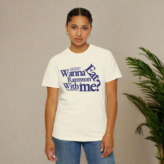 Person wearing a white t-shirt with blue text wanna eat ramenyon with me on a white background