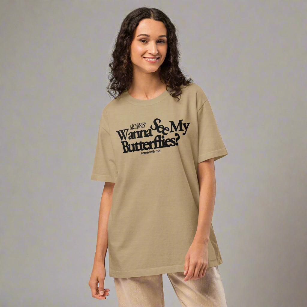 Woman wearing a beige khaki ARCHVSTS™ "Wanna See My Butterflies?" Vintage Oversized Tee