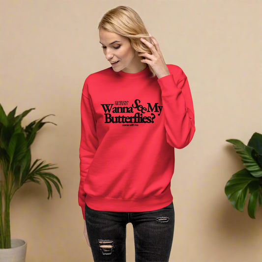 Person wearing a red wanna see my butterflies sweatshirt with text on a white background